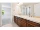 Bathroom with double sink vanity, modern fixtures, and a neutral color scheme at 11911 E Lake Cir, Greenwood Village, CO 80111