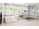 Modern bathroom featuring a soaking tub, walk-in glass shower with rainfall head, and large light-filled windows at 11911 E Lake Cir, Greenwood Village, CO 80111