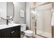 Modern bathroom features a sleek vanity, toilet, and glass-enclosed shower stall with white subway tile surround at 11911 E Lake Cir, Greenwood Village, CO 80111