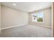 Spacious bedroom with a large window showcasing neighborhood views at 11911 E Lake Cir, Greenwood Village, CO 80111