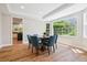 Elegant dining room with a large window, modern lighting, and stylish blue chairs at 11911 E Lake Cir, Greenwood Village, CO 80111