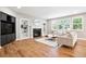 Bright living room with a fireplace, built-in shelves, and large windows providing ample natural light at 11911 E Lake Cir, Greenwood Village, CO 80111