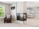 Main bedroom featuring a modern fireplace, sitting chair, and an ensuite bathroom with marble tile at 11911 E Lake Cir, Greenwood Village, CO 80111