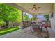 Covered outdoor kitchen with built-in grill, stone accents, and a seating area at 11911 E Lake Cir, Greenwood Village, CO 80111