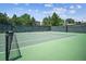 A well-maintained tennis court surrounded by trees offers a private recreational space at 11911 E Lake Cir, Greenwood Village, CO 80111