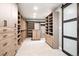 Large walk-in closet with built-in shelving and drawers for organized storage and display at 11911 E Lake Cir, Greenwood Village, CO 80111