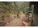 Spacious backyard with mature trees, landscaping, a wood deck and outdoor seating at 3065 Piney Ridge Rd, Evergreen, CO 80439
