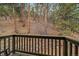 A view of the backyard from the deck, overlooking the forest and rocky hillside at 3065 Piney Ridge Rd, Evergreen, CO 80439