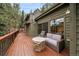 Inviting deck with a comfortable couch and a stone fire pit table perfect for outdoor gatherings and relaxation at 3065 Piney Ridge Rd, Evergreen, CO 80439