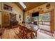 Cozy dining room with wood beam ceilings, a wood-burning stove, and access to a deck at 3065 Piney Ridge Rd, Evergreen, CO 80439