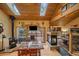 Open dining area with a fireplace and sliding glass doors to a deck with mountain views at 3065 Piney Ridge Rd, Evergreen, CO 80439