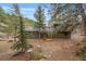 Charming exterior view of a multi-story home surrounded by mature trees at 3065 Piney Ridge Rd, Evergreen, CO 80439