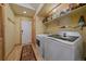 Bright laundry room with modern appliances and shelving for storage at 3065 Piney Ridge Rd, Evergreen, CO 80439