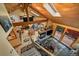 Open-concept living room with fireplace, skylights, wood beams and nature views at 3065 Piney Ridge Rd, Evergreen, CO 80439