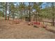 This scenic backyard has a sitting area, picnic table, outbuilding and a swing set for enjoying the outdoors at 3065 Piney Ridge Rd, Evergreen, CO 80439