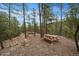 Hilly backyard with picnic table offers privacy and a natural landscape for outdoor activities and exploration at 3065 Piney Ridge Rd, Evergreen, CO 80439
