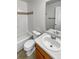 Bathroom with white tile, vanity, sink, toilet, and shower-tub combo at 1256 S Zeno Cir # E, Aurora, CO 80017
