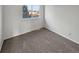 Neutral bedroom with carpet, white walls, and a window at 1256 S Zeno Cir # E, Aurora, CO 80017