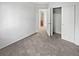 Bedroom showcasing carpet, an open closet, a view to the bathroom, and white walls at 1256 S Zeno Cir # E, Aurora, CO 80017