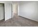 Carpeted bedroom with an open closet, open entry and white walls at 1256 S Zeno Cir # E, Aurora, CO 80017