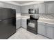 Well-equipped kitchen featuring gray cabinetry and black appliances at 1256 S Zeno Cir # E, Aurora, CO 80017