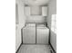 Convenient laundry room with washer, dryer, and overhead storage at 1256 S Zeno Cir # E, Aurora, CO 80017