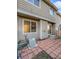 Back patio with red brick and an AC unit against the home's tan exterior at 1256 S Zeno Cir # E, Aurora, CO 80017