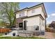 Side view of outdoor space with cozy seating and a hot tub, set against the backdrop of a home at 1373 S Garfield St, Denver, CO 80210