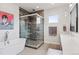 Sleek bathroom featuring modern fixtures, glass shower, and a soaking tub with stunning accent wall at 1373 S Garfield St, Denver, CO 80210