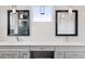 Bathroom featuring a double vanity, stylish mirrors, sleek lighting, and neutral decor at 1373 S Garfield St, Denver, CO 80210