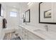 Bright bathroom featuring double sinks, subway tile shower, and neutral color palette at 1373 S Garfield St, Denver, CO 80210