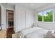 Well-lit bedroom with closet, view to laundry and large window at 1373 S Garfield St, Denver, CO 80210
