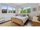 Bright bedroom with hardwood floors, large windows, and comfortable furnishings at 1373 S Garfield St, Denver, CO 80210