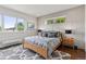 Primary bedroom with hardwood floors, large windows, decorative molding and a seating area at 1373 S Garfield St, Denver, CO 80210