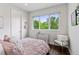 Cozy bedroom with large window, hardwood floors, and a view of mature trees at 1373 S Garfield St, Denver, CO 80210