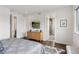 Bright bedroom features hardwood floors, a TV, and an ensuite bathroom with stylish decor at 1373 S Garfield St, Denver, CO 80210