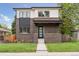 Charming two-story home with brick facade, black trim, and well-maintained landscaping at 1373 S Garfield St, Denver, CO 80210