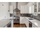 The chef's kitchen has white cabinets, stainless appliances, stylish subway tile and modern fixtures at 1373 S Garfield St, Denver, CO 80210