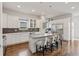 Gourmet kitchen featuring stainless steel appliances, granite countertops, and a large center island with seating at 1373 S Garfield St, Denver, CO 80210