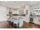 Gourmet kitchen featuring stainless steel appliances, granite countertops, and a large center island with seating at 1373 S Garfield St, Denver, CO 80210