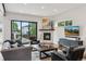 Cozy living room featuring a fireplace, hardwood floors, and sliding door access to outdoors at 1373 S Garfield St, Denver, CO 80210