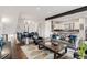 Open-concept living space with hardwood floors and designer finishes leading into dining room and kitchen at 1373 S Garfield St, Denver, CO 80210