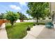 Serene backyard with lush green lawn, mature trees, and white fence at 1924 Yosemite St, Denver, CO 80220