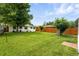 Spacious backyard with lawn, mature tree, and privacy fence at 1924 Yosemite St, Denver, CO 80220