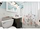 Charming bathroom with updated sink, tile, and floral shower curtain at 1924 Yosemite St, Denver, CO 80220