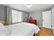 This bedroom offers hardwood floors, a light gray color scheme, and a large window at 1924 Yosemite St, Denver, CO 80220