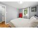 Bedroom featuring a red dresser, window views, and light grey walls at 1924 Yosemite St, Denver, CO 80220