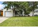 Charming single-story home featuring a well-maintained lawn and an attached one-car garage at 1924 Yosemite St, Denver, CO 80220