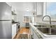 Well-lit kitchen with stainless steel appliances, granite countertops, and white cabinets, offering a modern cooking space at 1924 Yosemite St, Denver, CO 80220