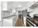 Updated kitchen featuring stainless steel appliances, granite countertops and an open layout at 1924 Yosemite St, Denver, CO 80220